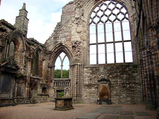 The ruined nave of Holyrood Abbey, with the great pointed window and carved stonework open to the sky